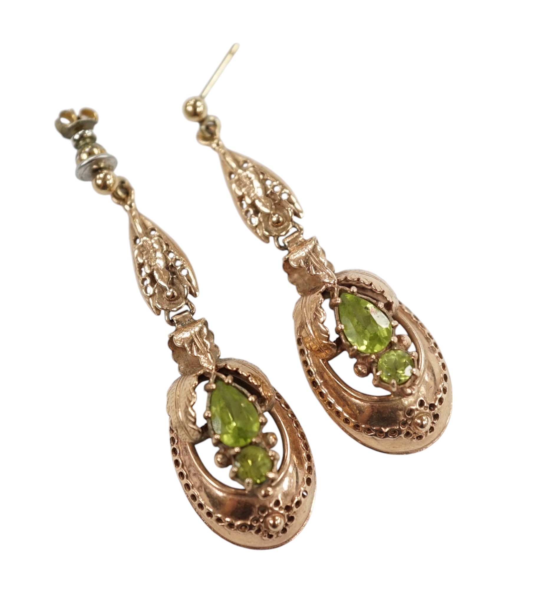 A pair of late 19th/early 20th century style yellow metal and two stone peridot set drop earrings, 48mm. Condition - poor to fair